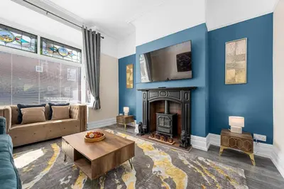 a living room with a couch and a fireplace at Luxury Modern Home Great Harwood - Sleeps Up to 8 in Great Harwood