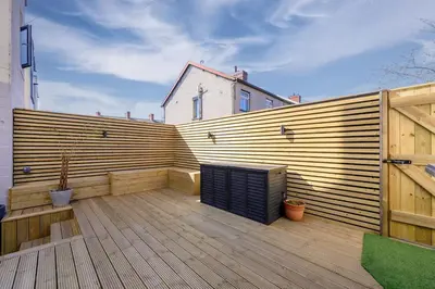 a wooden privacy fence on a wooden deck at Luxury Modern Home Great Harwood - Sleeps Up to 8 in Great Harwood