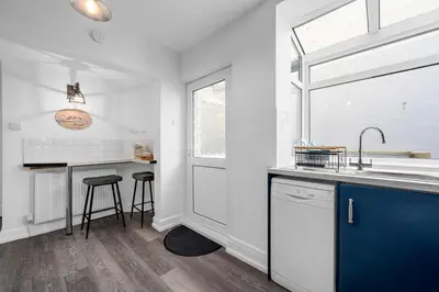 a white kitchen with a sink and a counter at Luxury Modern Home Great Harwood - Sleeps Up to 8 in Great Harwood