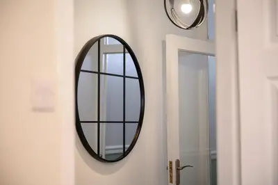 a mirror hanging on a wall next to a door at Luxury Modern Home Great Harwood - Sleeps Up to 8 in Great Harwood