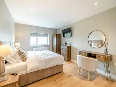 a bedroom with a bed and a desk and a mirror at Meadow View - Uk49066 in Mellor