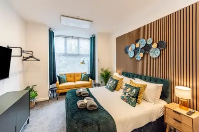 a bedroom with a bed with teddy bears on it at The Sage in Lytham St Annes