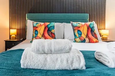 a bedroom with a bed with two pillows at The Sage in Lytham St Annes