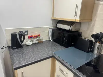 a kitchen counter with a coffee maker and a microwave at 2 Bedroom Apartment - Henry St Central Liverpool in Liverpool