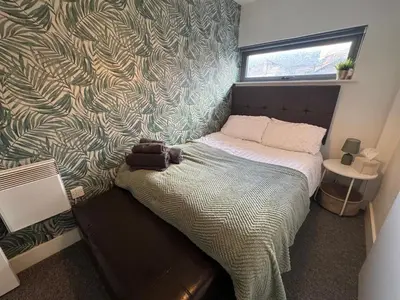 a small bed in a room with a wall at 2 Bedroom Apartment - Henry St Central Liverpool in Liverpool