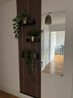 a wooden wall with potted plants and a mirror at 2 Bedroom Apartment - Henry St Central Liverpool in Liverpool