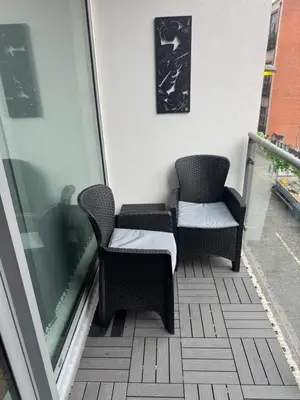 two chairs sitting on the balcony of a building at 2 Bedroom Apartment - Henry St Central Liverpool in Liverpool