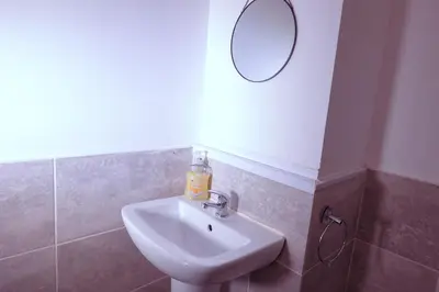 a bathroom with a sink and a mirror on the wall at Edinburgh Road Guest House in Liverpool