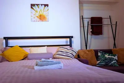 a bedroom with a bed with colorful pillows at Edinburgh Road Guest House in Liverpool