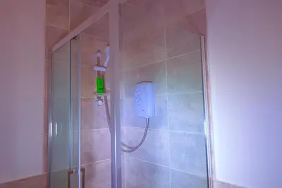a shower stall with a soap dispenser in a bathroom at Edinburgh Road Guest House in Liverpool