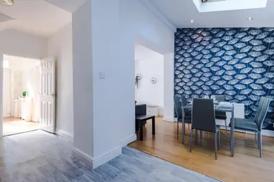 a dining room with a table and chairs at Charming Home in Merseyside, sleeps 7 in Liverpool