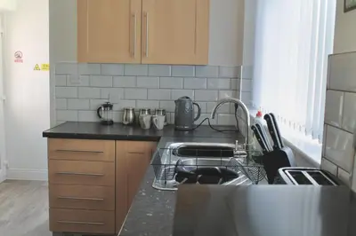 a kitchen with a sink and a dishwasher at Your lovely 3-bed home-from-home in Bamber Bridge in Bamber Bridge