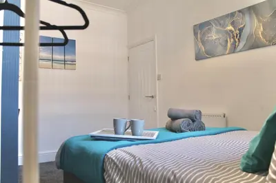 a bedroom with a bed with a tray on it at Your lovely 3-bed home-from-home in Bamber Bridge in Bamber Bridge