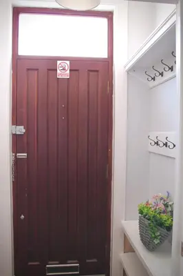 a brown door in a hallway with a mirror at Your lovely 3-bed home-from-home in Bamber Bridge in Bamber Bridge