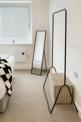 a bedroom with two mirrors and a wicker table at Copper Suite - 2Bed Elegance - Parking in Liverpool