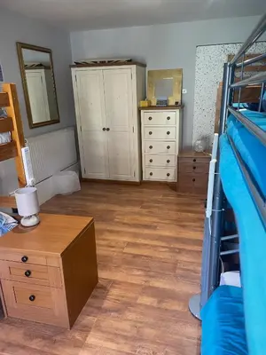 a bedroom with a bunk bed and a wooden floor at Norwood Manor in Southport