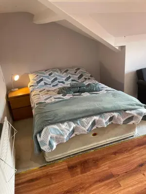 an unmade bed in a room with at Norwood Manor in Southport