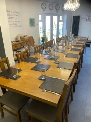 a large wooden table with chairs and a large room at Norwood Manor in Southport