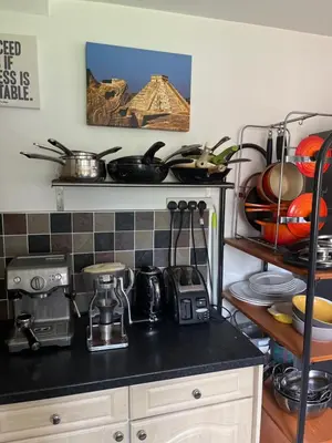 a kitchen with a counter top with pots and pans at Quiet times away from city noise, but not too far! in Skelmersdale
