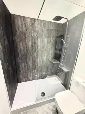 a bathroom with a shower and a toilet at Hornby Hottub and Jacuzzi Suites in Blackpool
