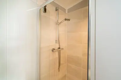 a shower with a glass door in a bathroom at Silverdale Lodge, HotTub, Wi-FI, Quiet & Sleeps 4 in Warton