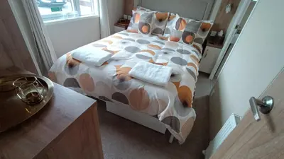 a bedroom with a bed with pillows on it at 95C Sunset View Port Haverigg Marina Village in Millom