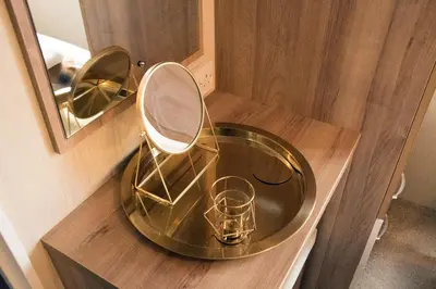 a glass sink with a mirror on a wooden counter at 95C Sunset View Port Haverigg Marina Village in Millom