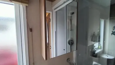 a bathroom with a mirror and a sink at 95C Sunset View Port Haverigg Marina Village in Millom