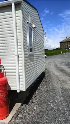 a fire hydrant next to the side of a building at 95C Sunset View Port Haverigg Marina Village in Millom