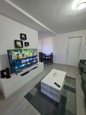 a living room with a large flat screen tv at Serene room in Liverpool