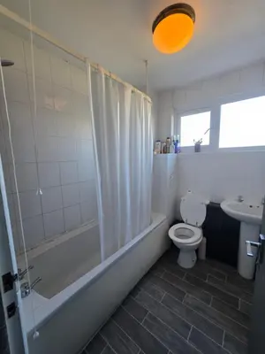 a bathroom with a tub and a toilet and a sink at Serene room in Liverpool