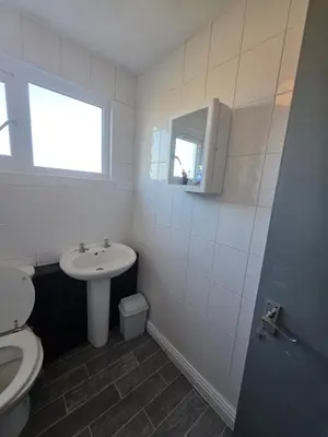 a white bathroom with a sink and a toilet at Serene room in Liverpool