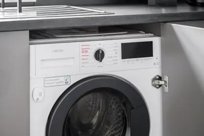 a white washing machine under a counter in a kitchen at Free Parking Stunning 3Bedroom Home In Wigan in Wigan