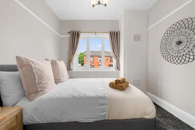 a bedroom with a bed with a teddy bear on it at Free Parking Stunning 3Bedroom Home In Wigan in Wigan