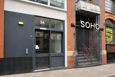 a store front with the door of a store at Central Apt With Balcony - Walk to Bars & Stations in Liverpool
