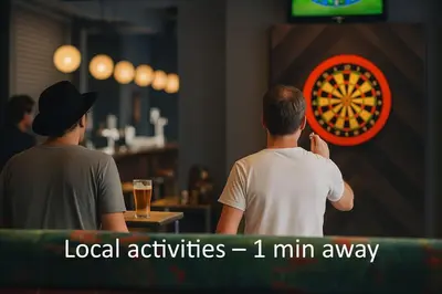 two men playing a game of darts in a bar at Central Apt With Balcony - Walk to Bars & Stations in Liverpool