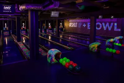 a bowling alley with pins and balls on the lanes at Central Apt With Balcony - Walk to Bars & Stations in Liverpool