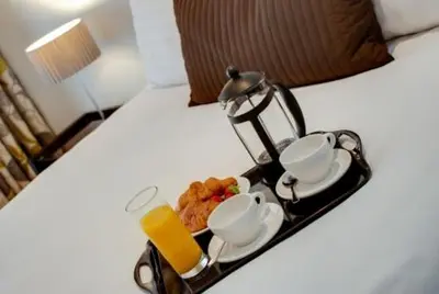 a breakfast tray with affeepot and cups on a bed at 3 Bedroom Apartment Central Liverpool in Liverpool