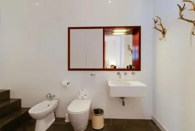 a bathroom with a toilet and a sink and a mirror at 3 Bedroom Apartment Central Liverpool in Liverpool