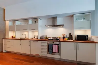 a kitchen with white cabinets and a counter top at 3 Bedroom Apartment Central Liverpool in Liverpool