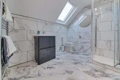 a bathroom with a shower and a toilet and a sink at The Rockfield by Serene Stays Stylish 6BR near Anfield with Bar Virgin Media and Fast WiFi in Liverpool