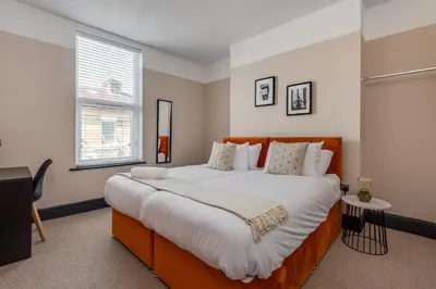 a bedroom with a large bed and a window at The Rockfield by Serene Stays Stylish 6BR near Anfield with Bar Virgin Media and Fast WiFi in Liverpool