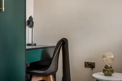 a chair in front of a desk with a lamp at The Rockfield by Serene Stays Stylish 6BR near Anfield with Bar Virgin Media and Fast WiFi in Liverpool