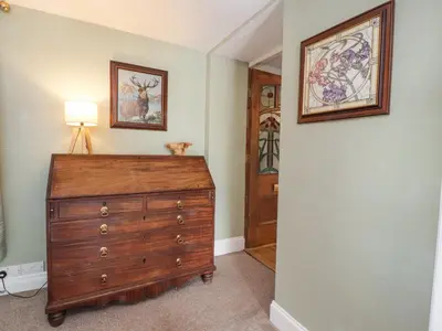 a room with a dresser with a lamp on top of it at Stoneycross Cottage in Preston