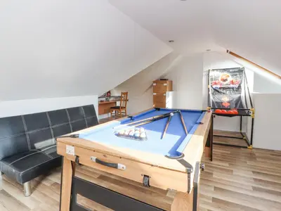 a living room with a pool table and a couch at Stoneycross Cottage in Preston