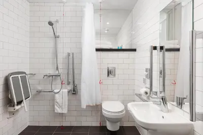 a white bathroom with a toilet and a sink at Tune Hotel Liverpool in Liverpool