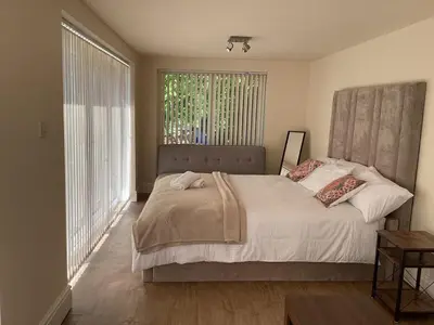 a bedroom with a bed and a large window at Golf view lodge in Lostock