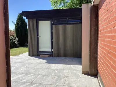a building with a large window on the side of it at Golf view lodge in Lostock