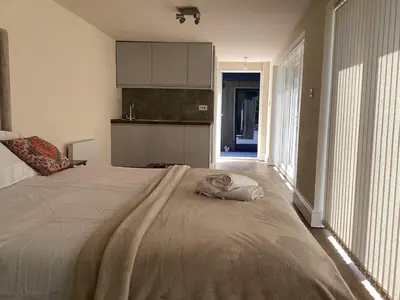 a bedroom with a large bed with a towel on it at Golf view lodge in Lostock