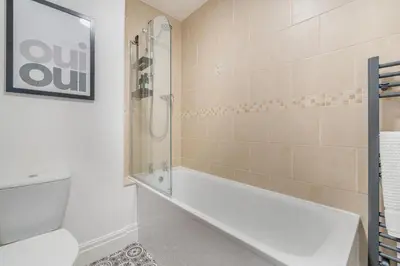a bathroom with a shower and a white bath tub at 1 Bed in Weeton oc-c32015 in Great Singleton